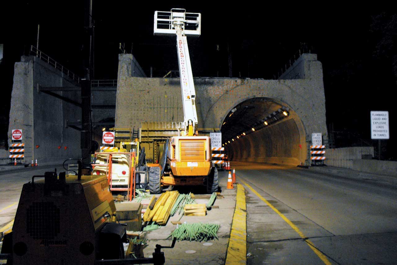 Two Conjet Robot 363 hydrodemolition machines have been adapted to suit the curvature of the horseshoe shaped walls of the twin Liberty Tunnels Conjet Robot 363 hydrodemolition machine
