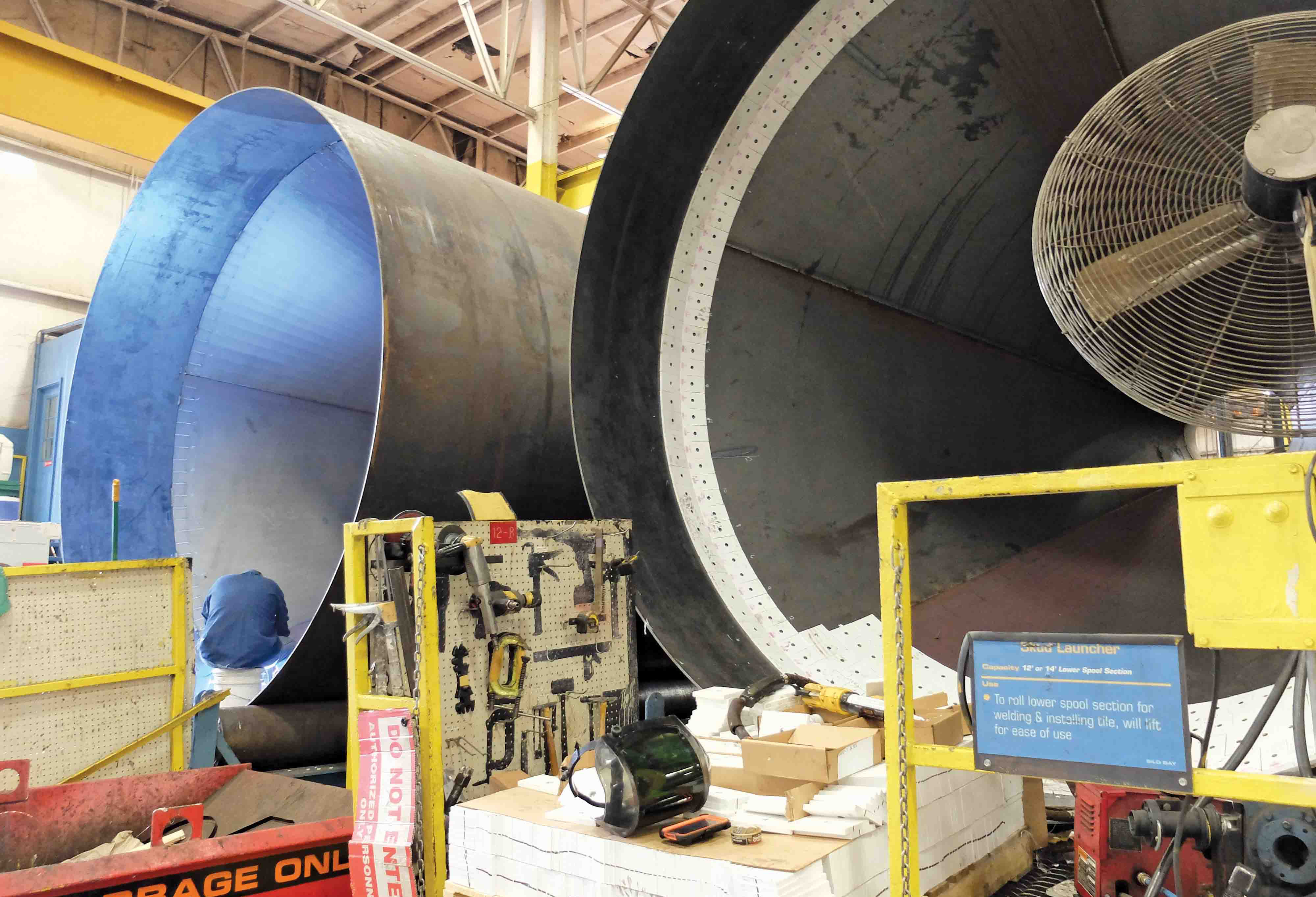 Steep angles in the cones reduce material segregation while ceramic tiles reduce wear Double Barrel drum, Astec