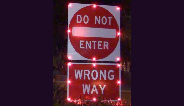 Wrong-way signs with 24-hour flashing LED lights warn drivers not to enter the exit ramp Wrong-way signs with 24-hour flashing LED lights warn drivers not to enter the exit ramp