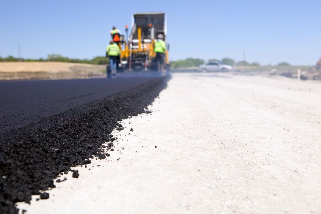 Blacktop Paving Road with Paver and Dump Truck | Photo: Shell Blacktop Paving Road with Paver and Dump Truck | Photo: Shell