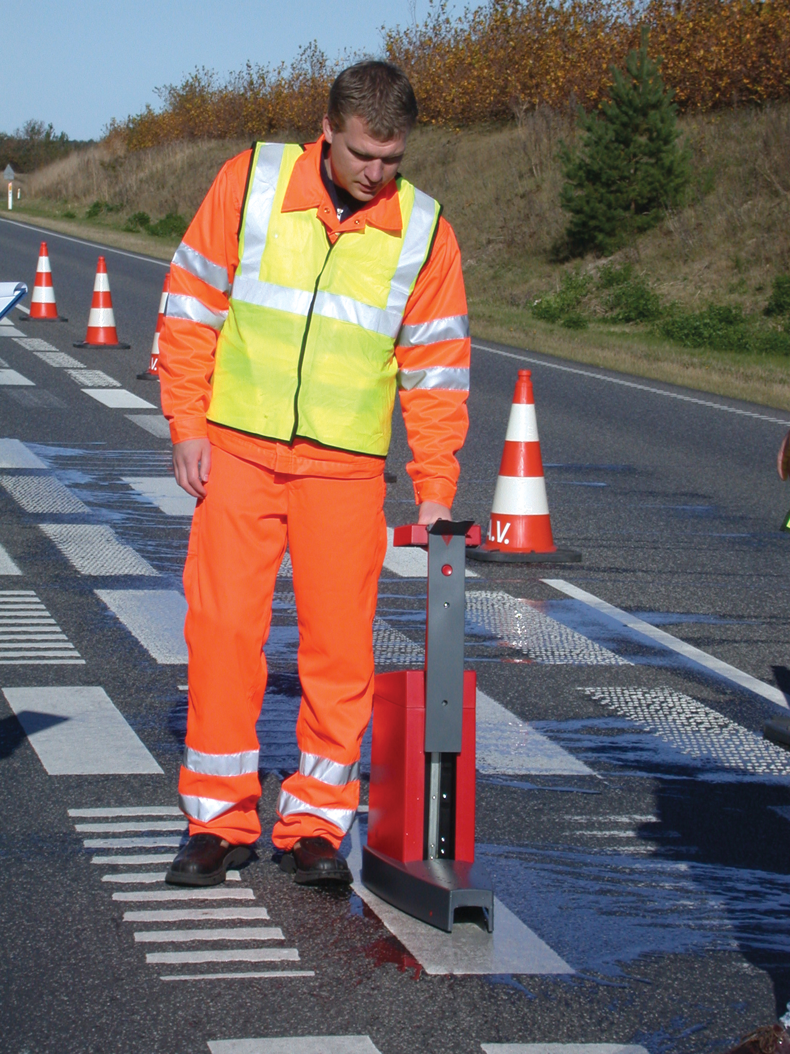 DELTA's portable LTL-X Retrometer for measuring the retroreflection of road markings Man using DELTA retrometer