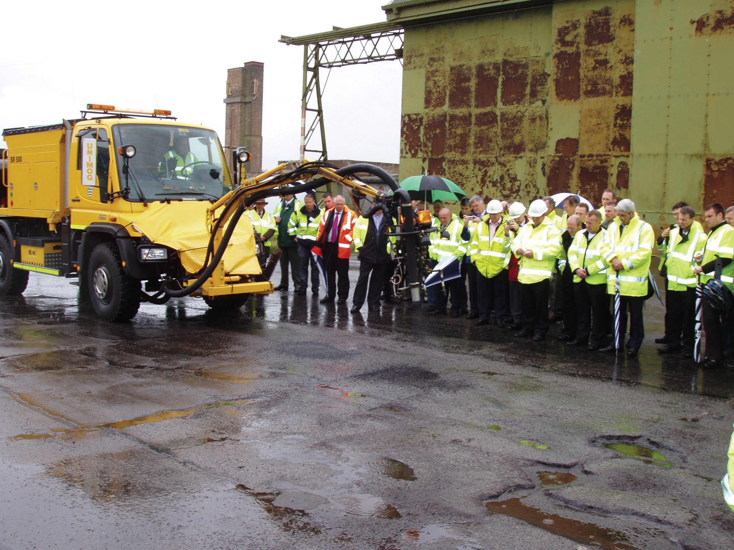 Visitors from highways authorities and contractors at the Wiltshire demonstration of the new Schmidt Savalco road repair patcher Visitors from highways authorities and contractors at the Wiltshire demonstration