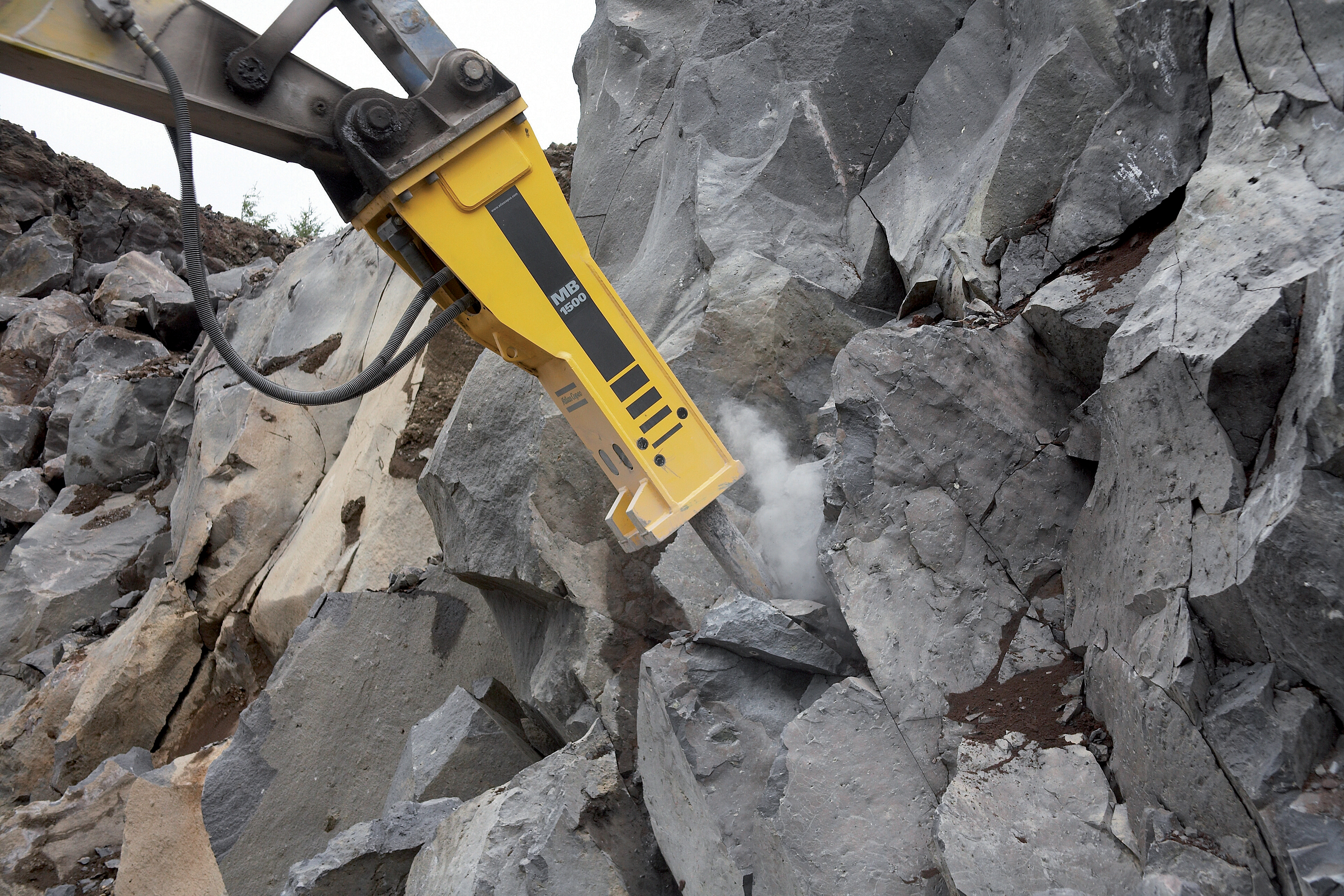 Low maintenance requirements and high performance are claimed for Atlas Copco's mid-sized MB1500 breaker Drilling breaker into rocks