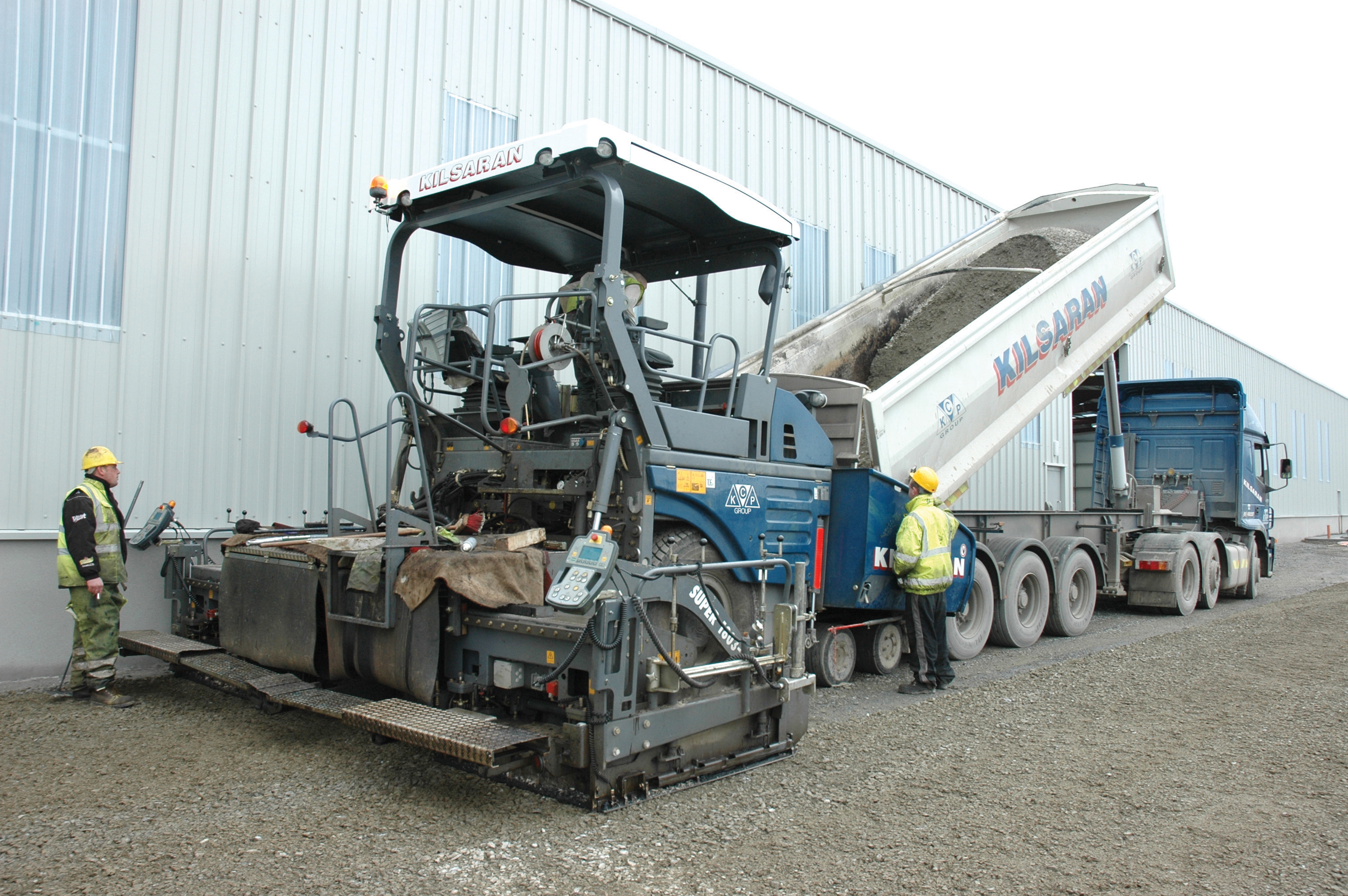 Kilsaran's Vögele 1803-2 paver, one of four such machines operated by the company
Dump truck emptying concrete into a Vogele paver