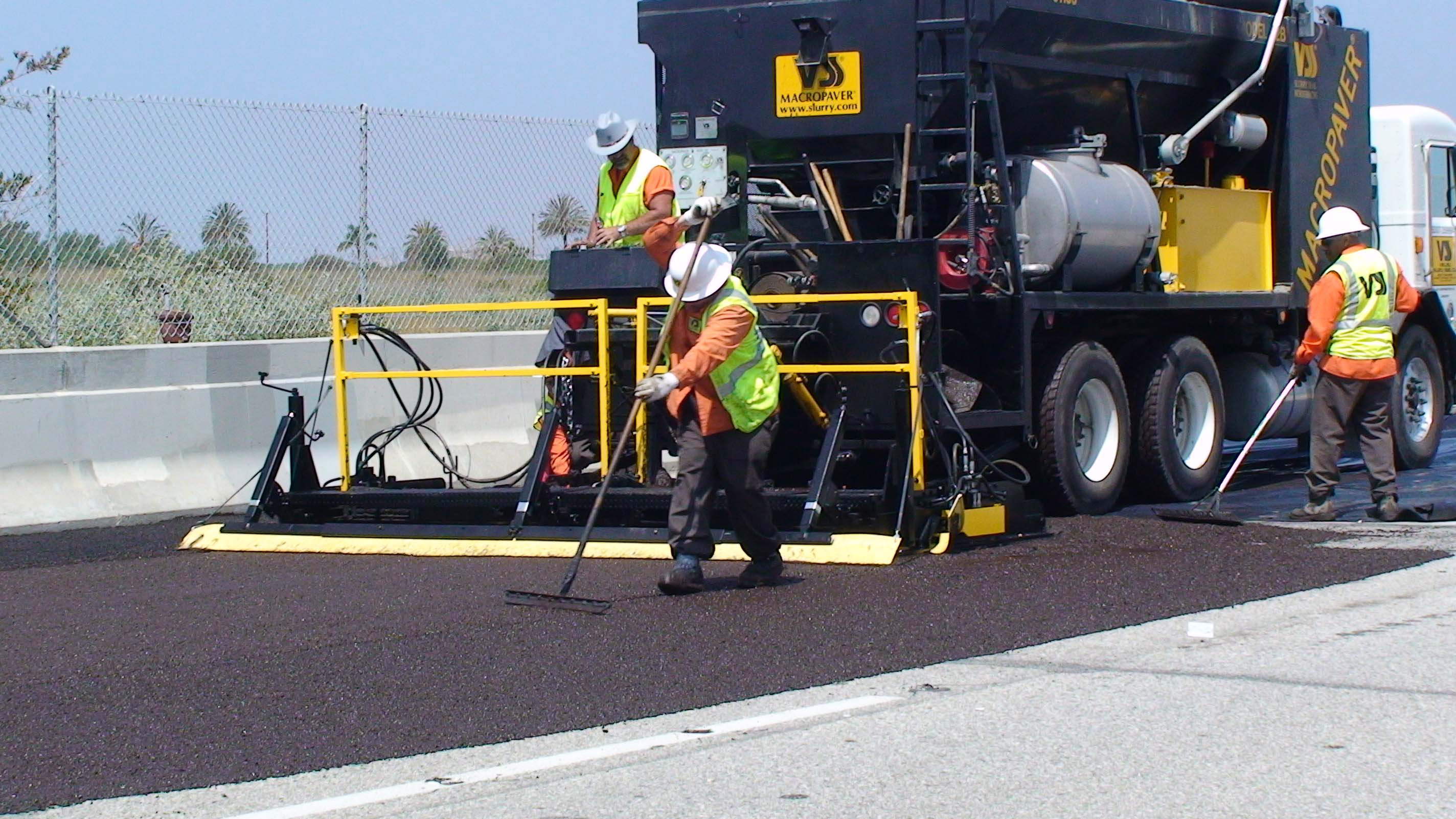 The Expandable box from VSS in action slurry sealing a road VSS Expandable box
