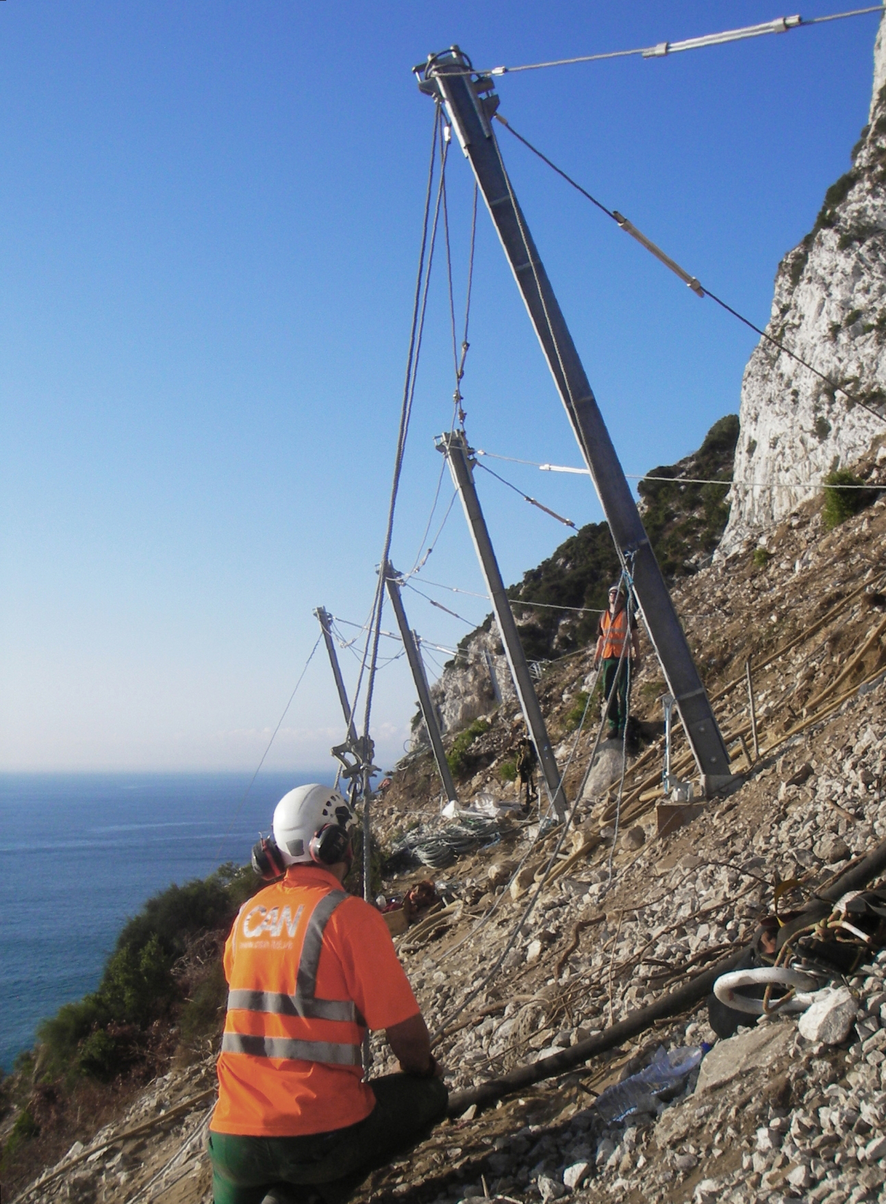 The fence posts are positioned down-slope with steel cables fixed to back-stay anchors, securely fixed in a reversed v-formation, up-slope of the fence run Rock Fall Protection