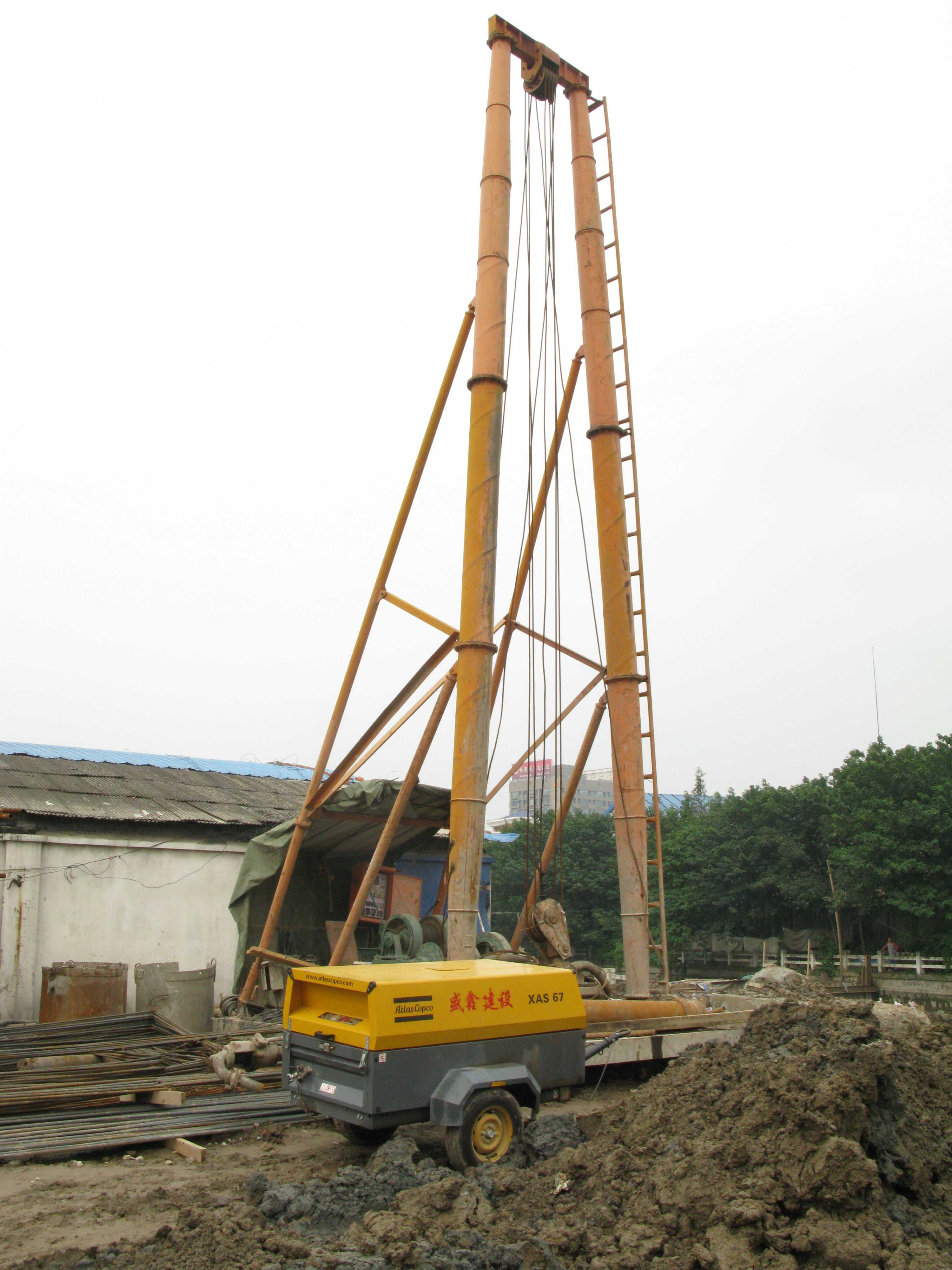 An Atlas Copco oil-injected rotary screw compressor is working on piling for the bridge, which will span a river in Shanghai's Pu Tuo district Atlas Copco oil-injected rotary screw compressor