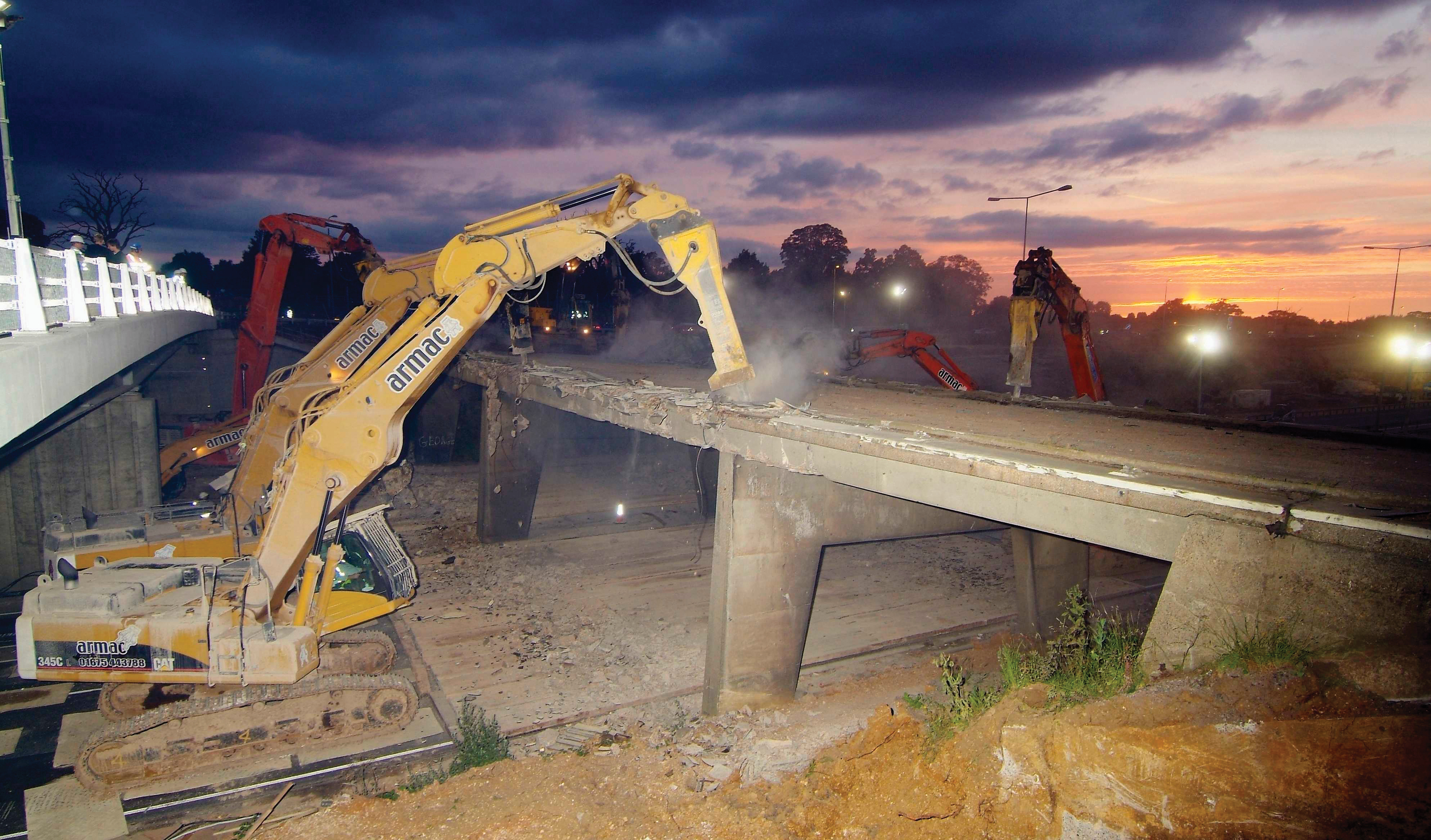 Using long reach demolition equipment allows structures such as overpasses and highway bridges to be removed quickly and safely Bridge demolition in progress