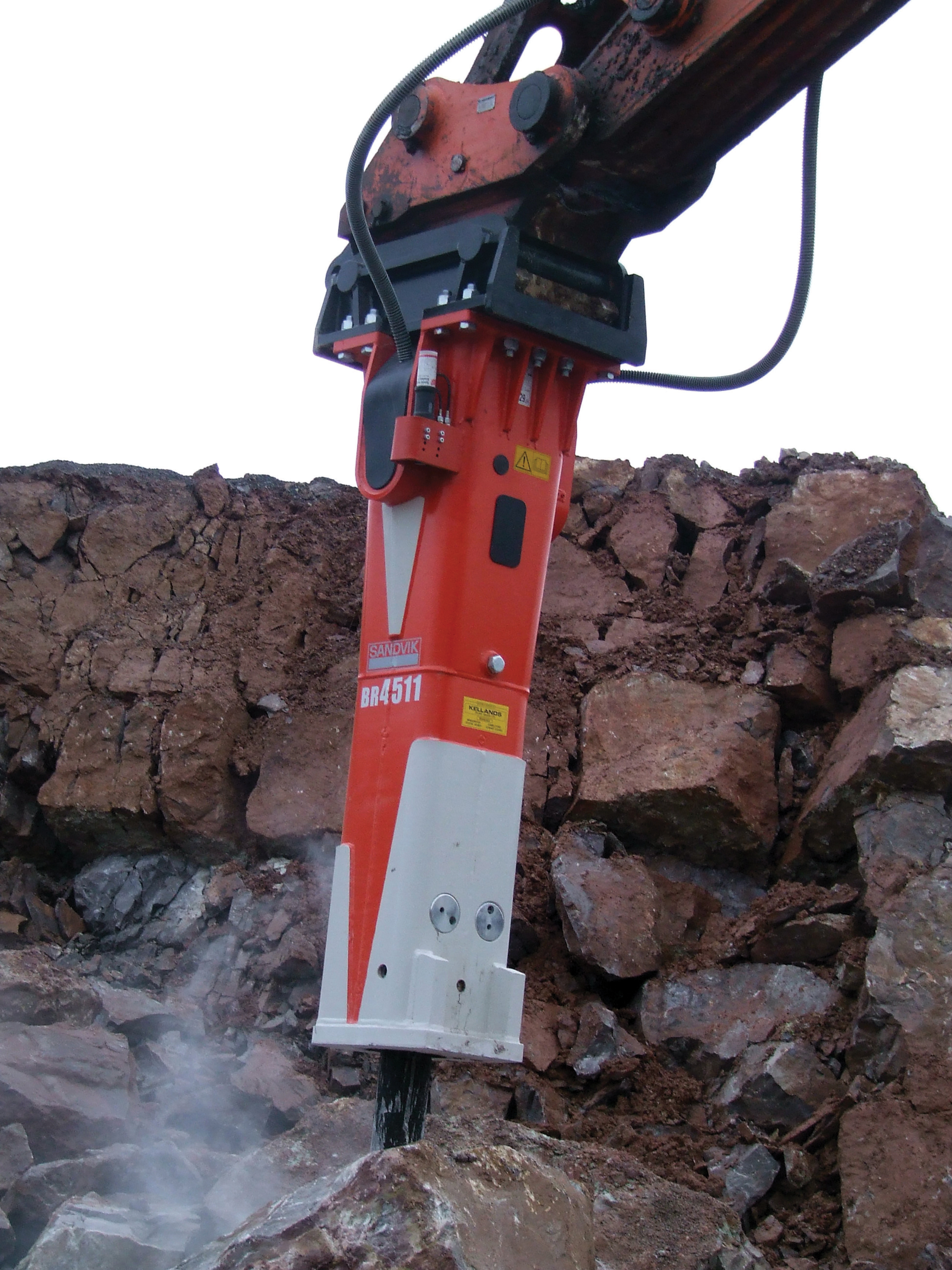 Working from a 5m high bench, the breaker loosens the fractured rock which is then processed through the sites crushing and screening plant Sandvik Hydraulic Breaker at work