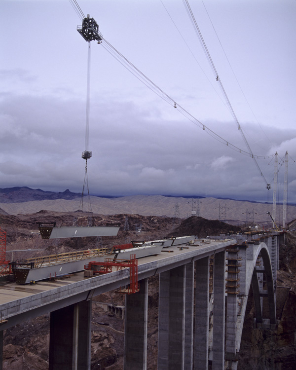 The highline hoists and transports a steel girder out onto the arch for placement between Pier 10 and 11 spandrel column pier caps during construction Highline hoisting girder