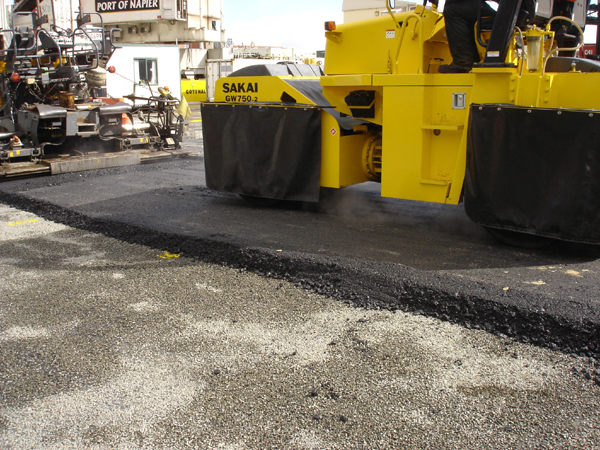 As mix cooled rapidly in the raw weather, the crew operated the Sakai pneumatic-roller in vibratory mode to expedite compaction Sakai pneumatic-roller