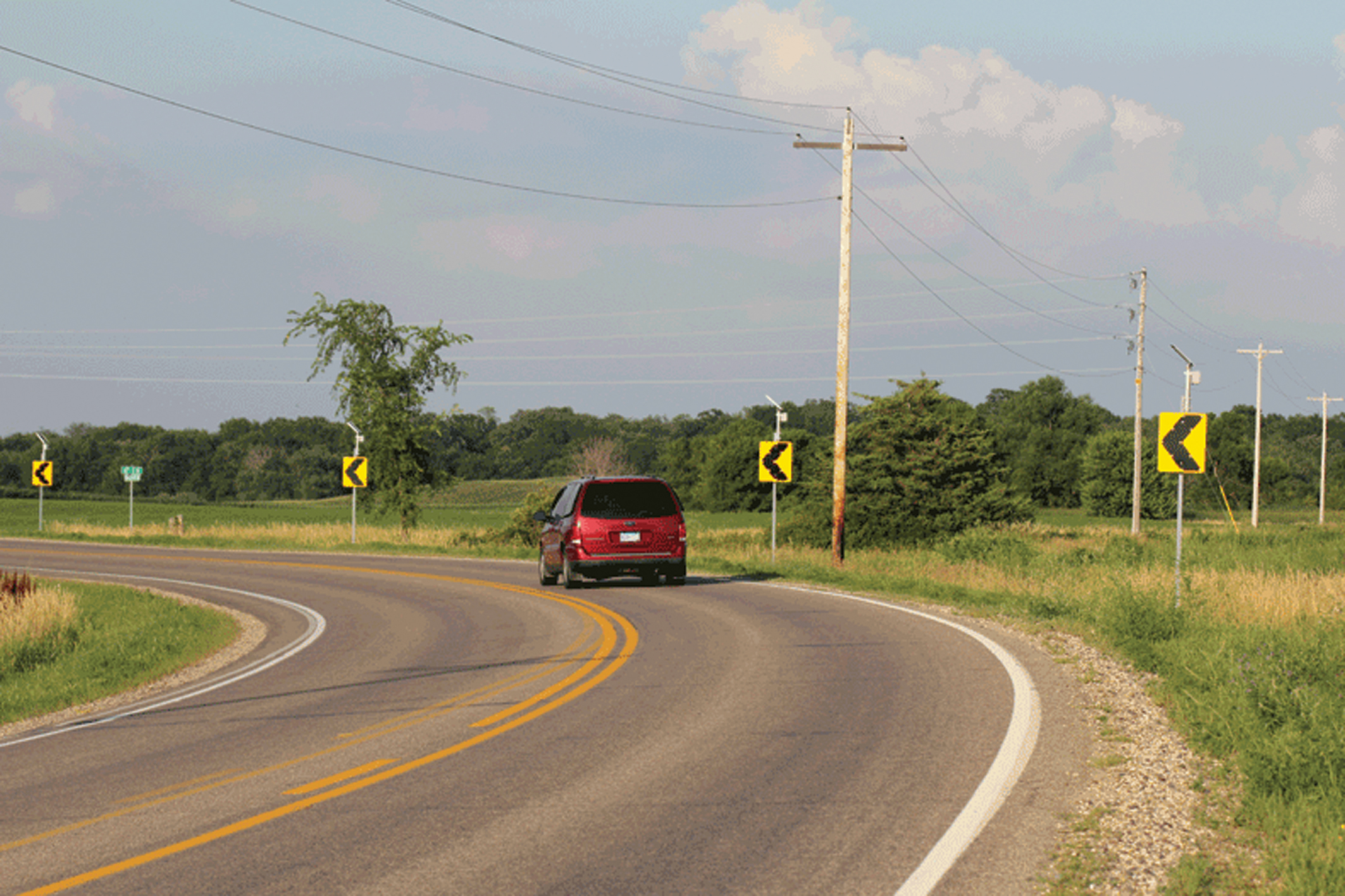 Highlighting danger spots such as curves can reduce the risk of roadway departures car going around a marked corner