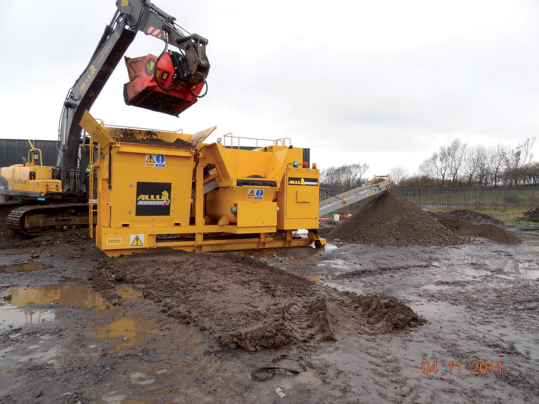 An ALLU SureMix being loaded with one of the company's buckets ALLU SureMix being loaded