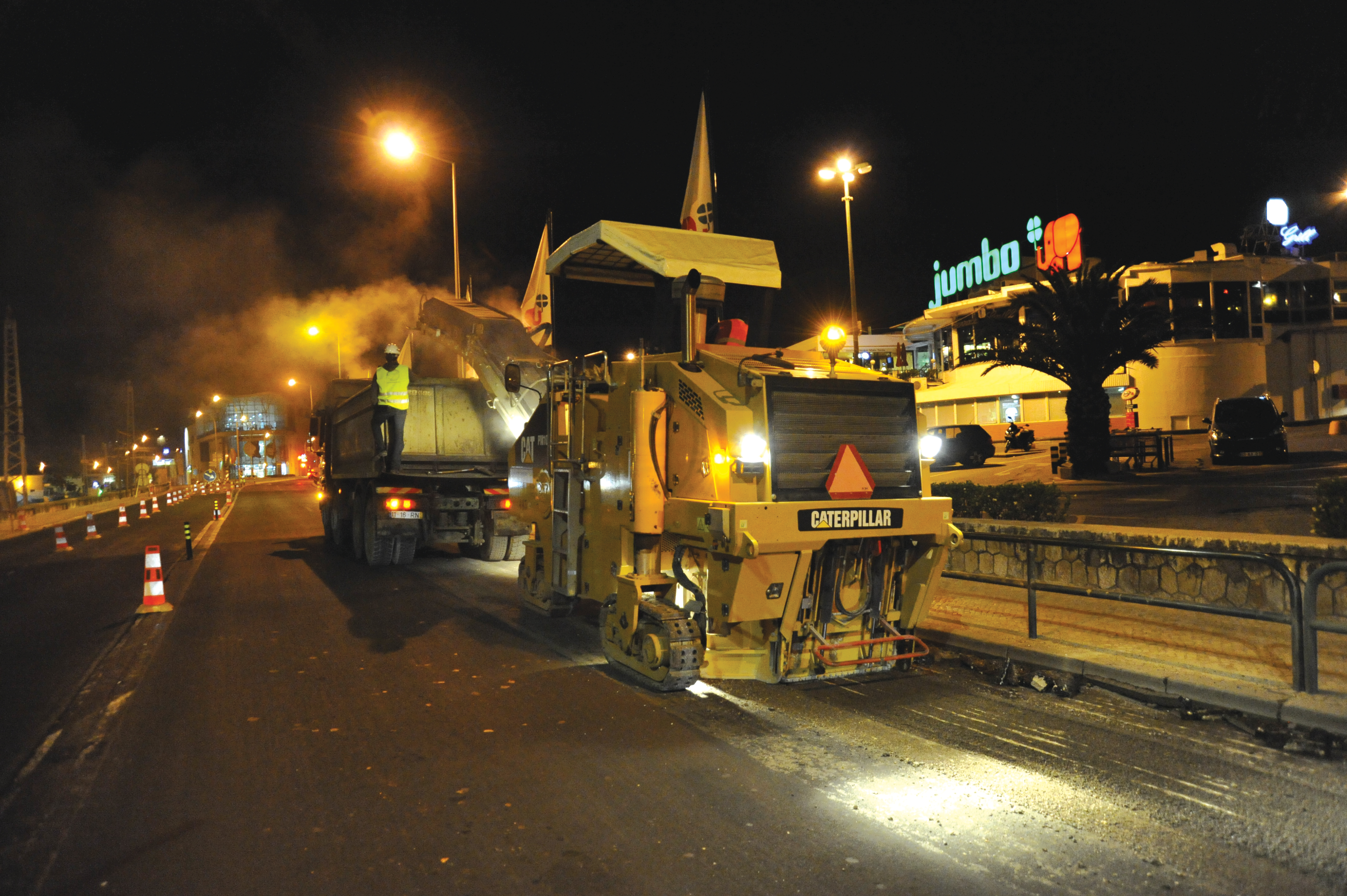 Caterpillar pavers were used during race-against-the-clock road drainage improvements to a key Portugal tourist village access route Cat paver