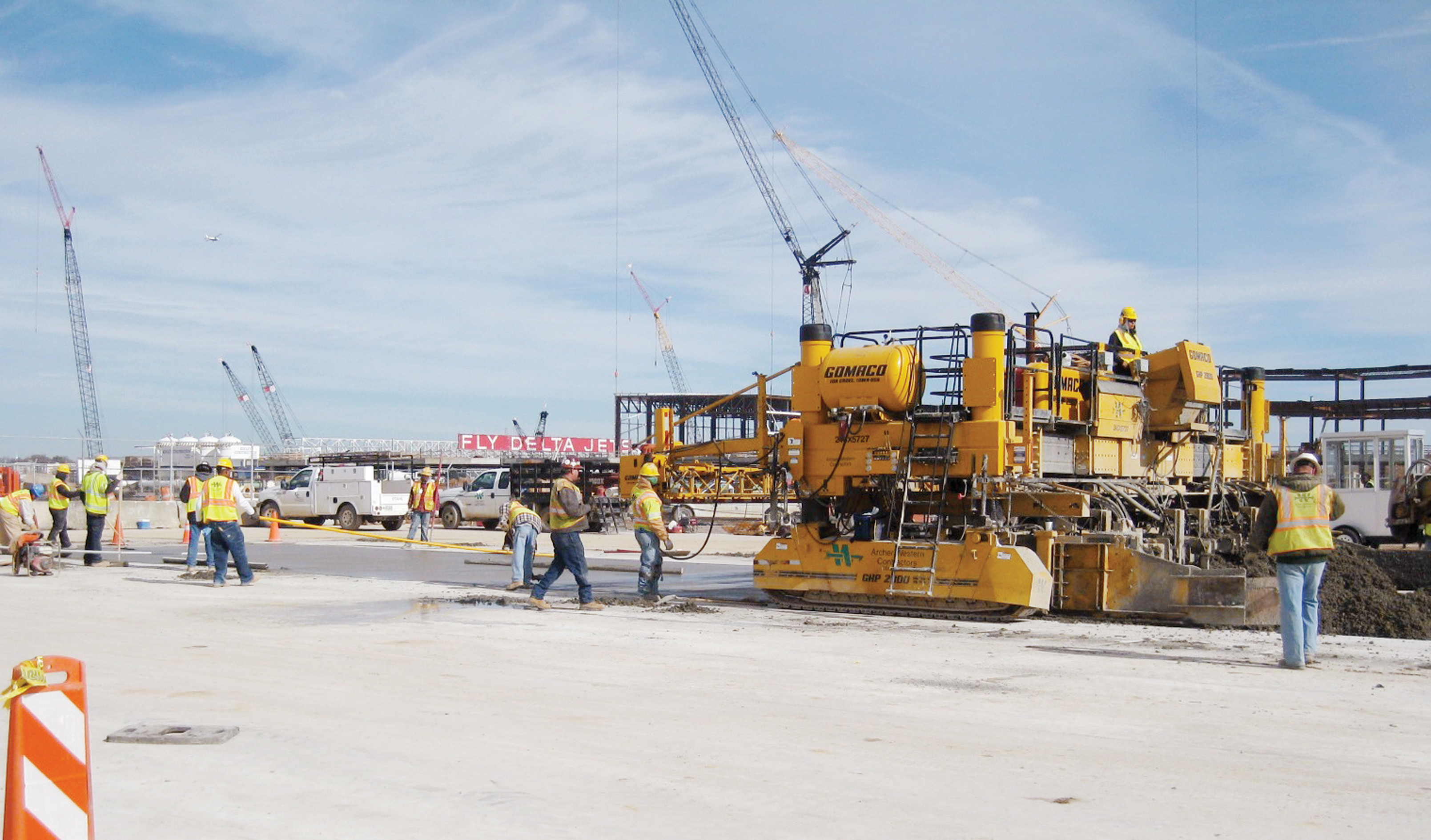 Construction of the new terminal building was underway while the apron was being slipformed, resulting at times in job-site congestion while limiting paving production job-site congestion