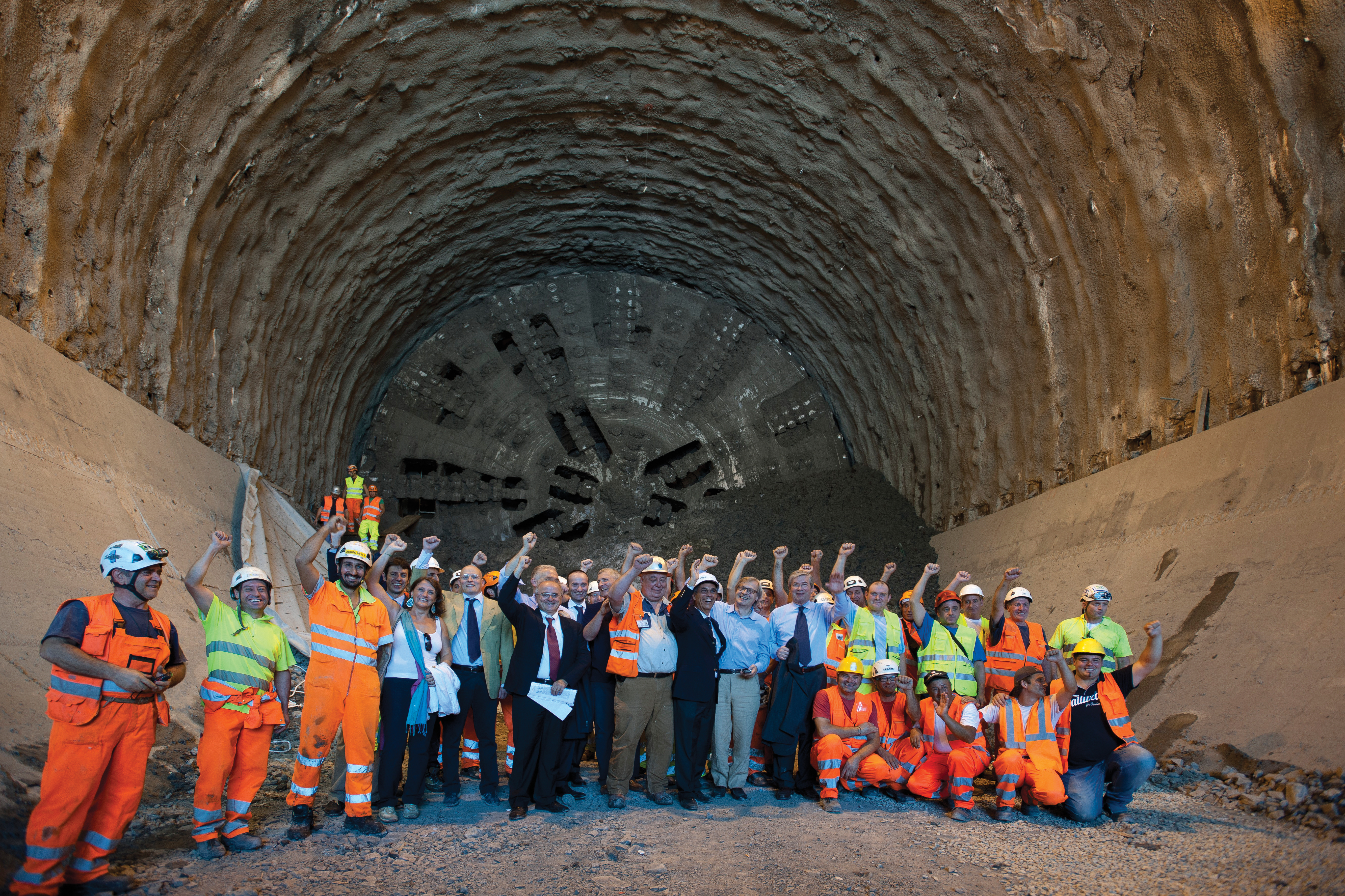 Workers celebrate the completed installation of the first of two two-lane tubes in the Sparvo Tunnel, part of ongoing route extension works on Italy’s A1 motorway Sparvo Tunnel