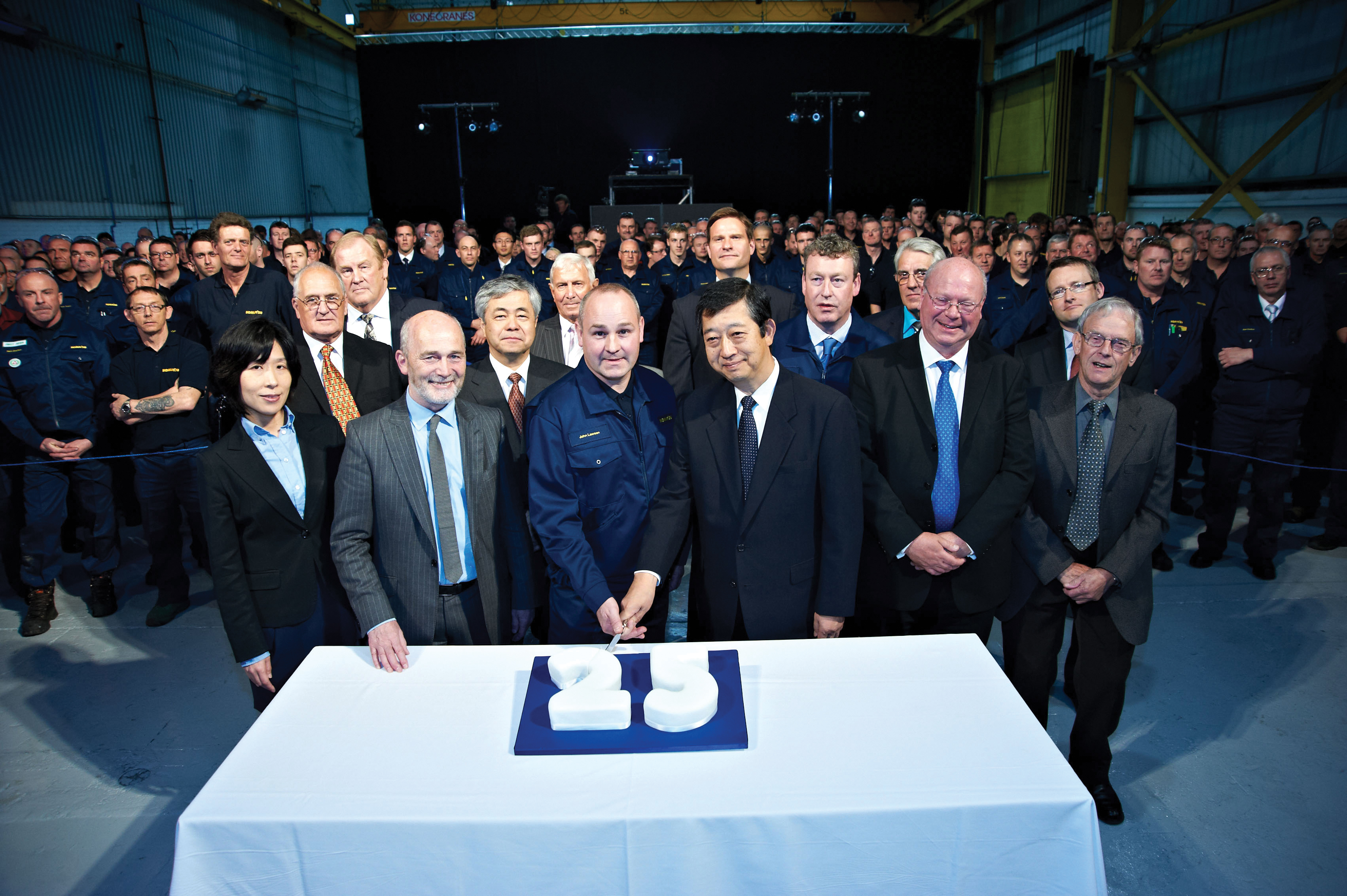 All guests and personnel gathers for the cake cutting ceremony Komatsu cake cutting for 25th anniversary