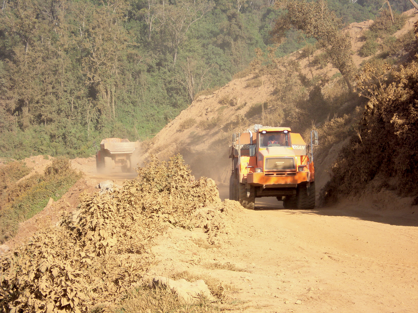 Doosan ADTs constantly move up and down the steep mountain roads Doosan ADTs steep mountain roads