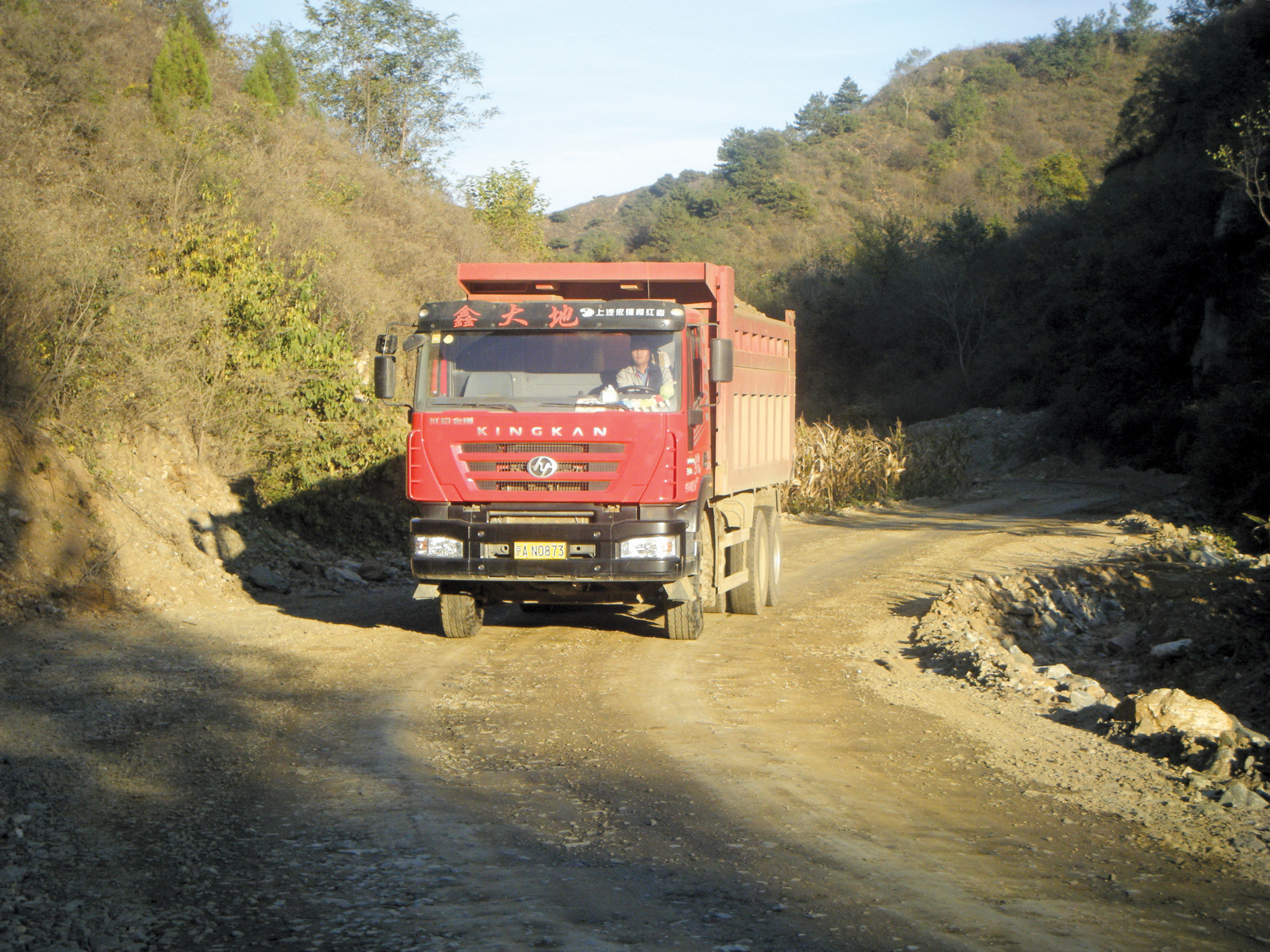On/off highway trucks haul the material to another site for crushing and screening at present Caterpillar On/off highway trucks