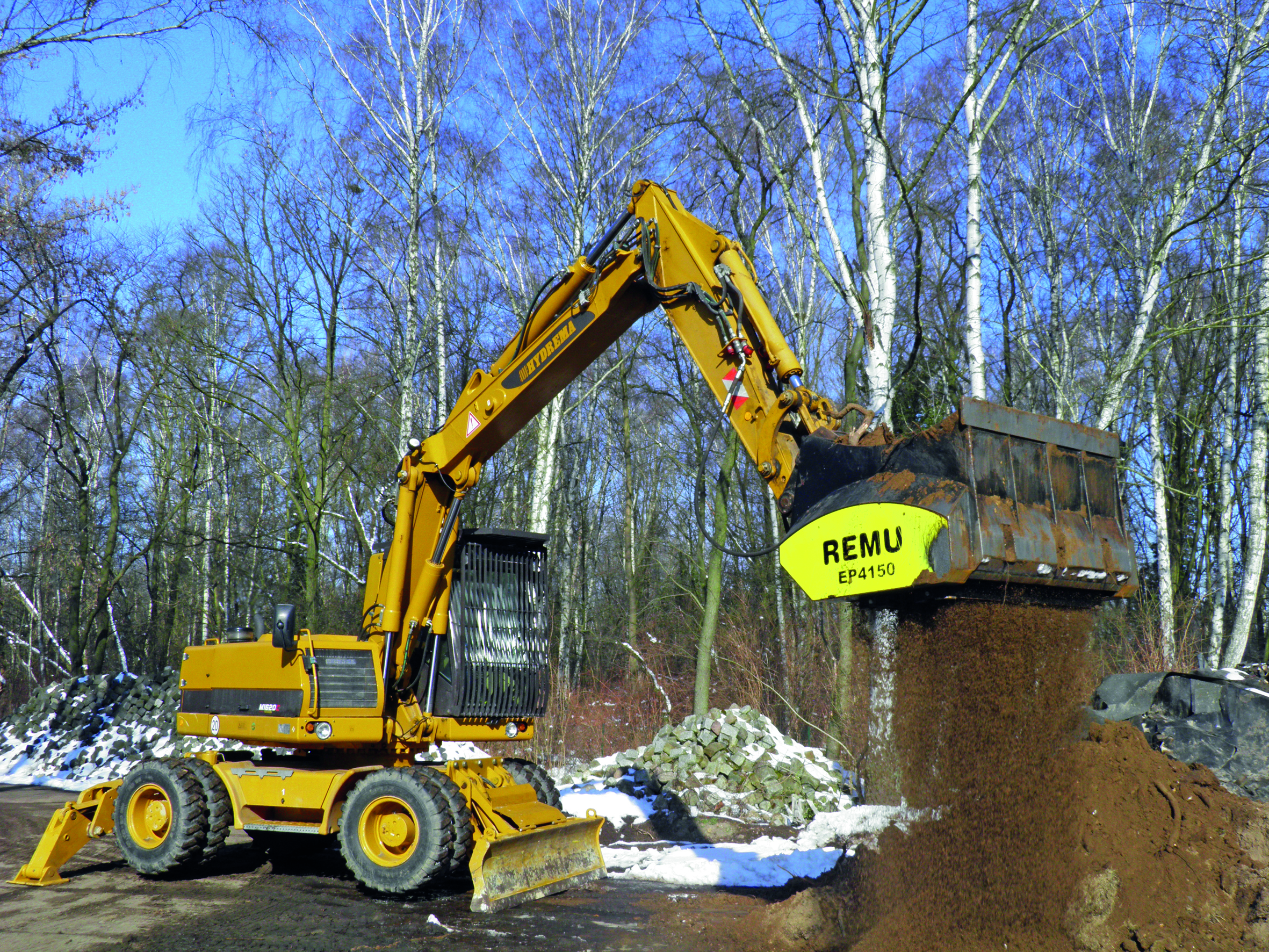 Remu screening bucket EP4150 attached to a wheeled excavator landscaping Remu Screen Buckets
