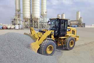 The new Cat K Series small wheeled loaders are equipped with a stepless, four-range, hydrostatic drive system that allows independent control of ground speed and engine speed for efficient operation of hydraulically powered work tools Catewrpillar K Series small wheeled loaders