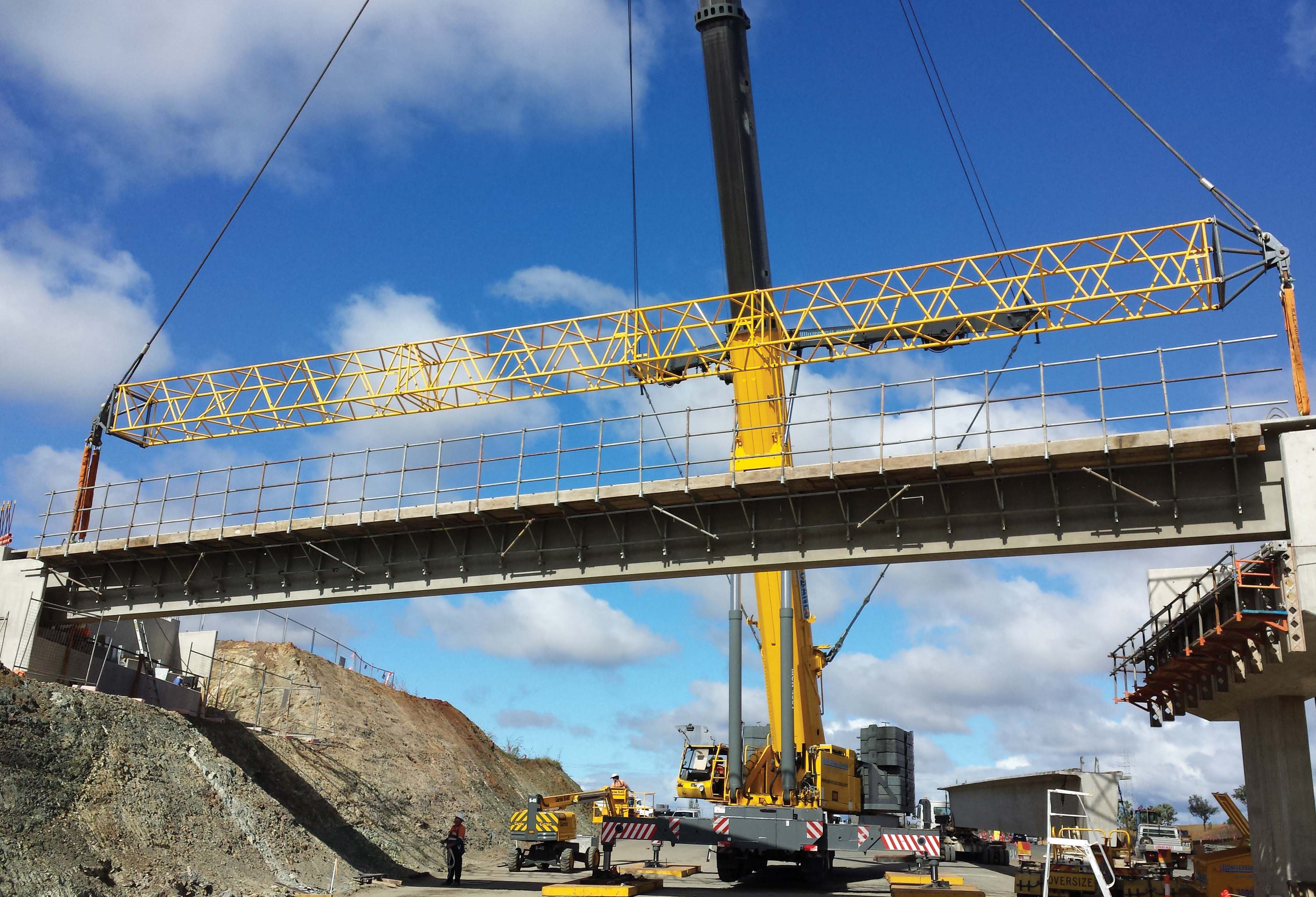 An Australian crane specialist Universal Hire is using two Manitowoc cranes to help construct a bridge on the Bruce Highway Manitowoc cranes constructing a bridge