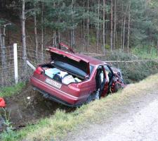 crashed car by the side of the road