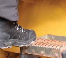 Climbing steps wearing Tomcat Boots