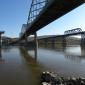From the eastern bank of the Peace River, the new piers await arrival of the deck