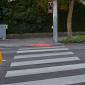 Swarco’s SafeLight shines a red light down to the pavement next to the traffic light pole