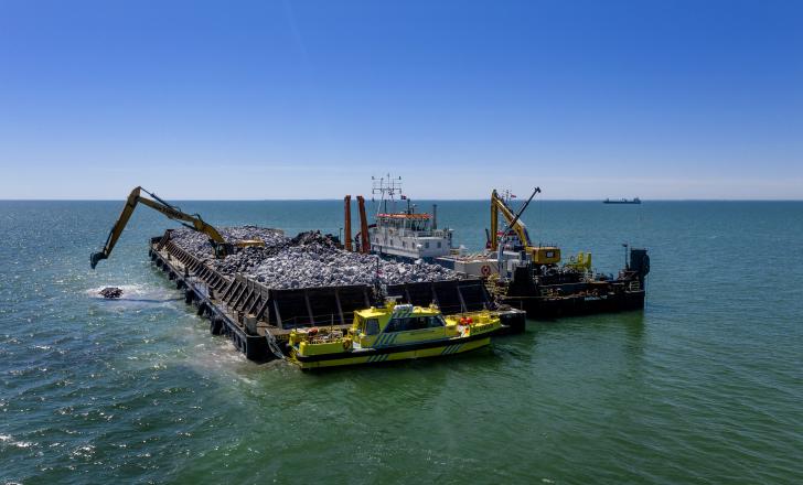 Work continues in June on a breakwater for the harbour in Rødbyhavn where sections of the tunnel will be constructed and floated out for placement (photo copyright Femern/Nils Lund Pedersen)