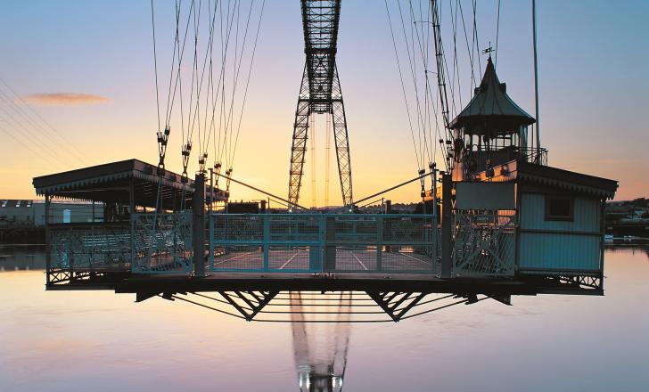 The transporter’s vehicle-carrying gondola hangs suspended from the upper structure, close to the River USk’s high-tide mark