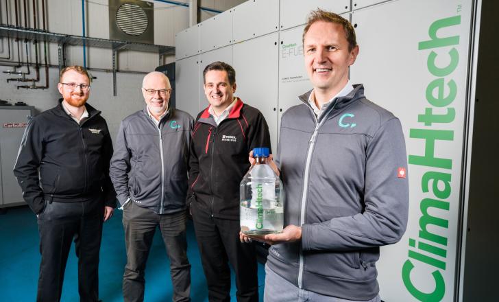From left to right: Andy Harris, advanced engineering manager at Wrightbus; Roy Douglas, chief technical officer and co-founder at CATAGEN; David Trimble, group engineering director at Terex Materials Processing; Andrew Woods, chief executive and co-founder at CATAGEN - holding CATAGEN’s ClimaHtech E-Fuel GEN Reactor (image courtesy Terex Materials Processing)