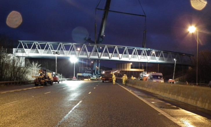 The new bridge is lifted into position over the M5 Motorway New Bridge