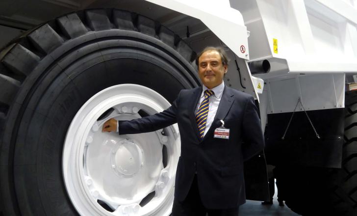 Dr Maurizio Perlini, pictured with a Perlini DP 705 WD dump truck at Samoter-Asphaltica 2014 Dr Maurizio Perlini next to Perlini DP 705 WD dump truck