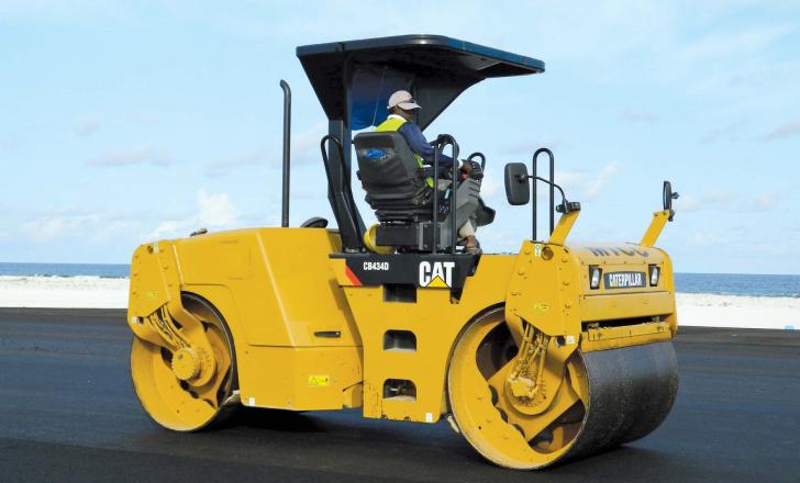 Compaction machines followed the pavers closely to ensure the surface was brought to the required specification Caterpillar compaction machine